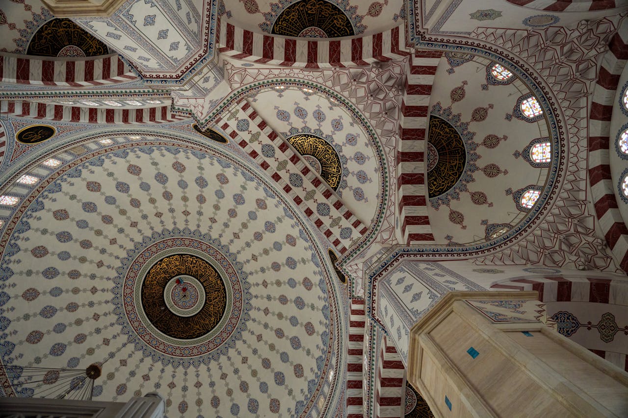Explore the intricate patterns and design of a mosque ceiling dome captured in a stunning architectural photograph.